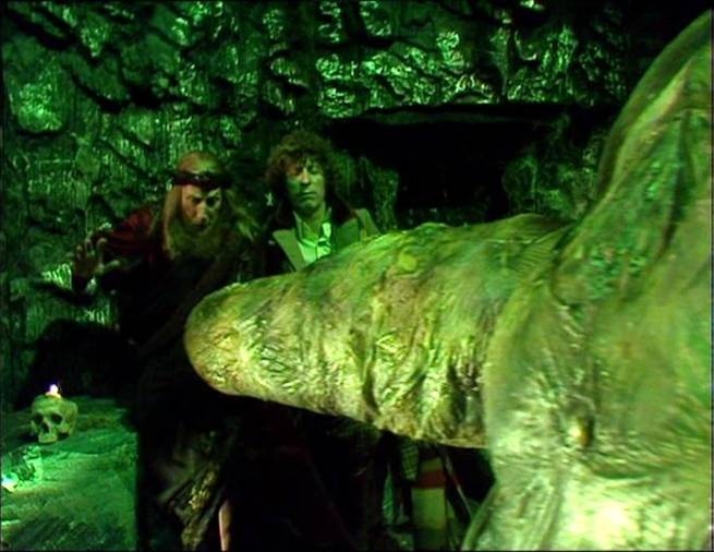 Screencap from The Creature from the Pit: In an underground mine, the Doctor and Orgulon face down an extremely phallic large protrusion.