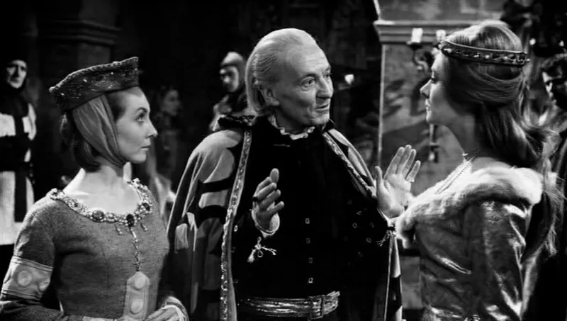 Screencap from The Crusade: The First Doctor and Vicki, in medieval fancy clothes, stand opposite Princess Joanna of England.