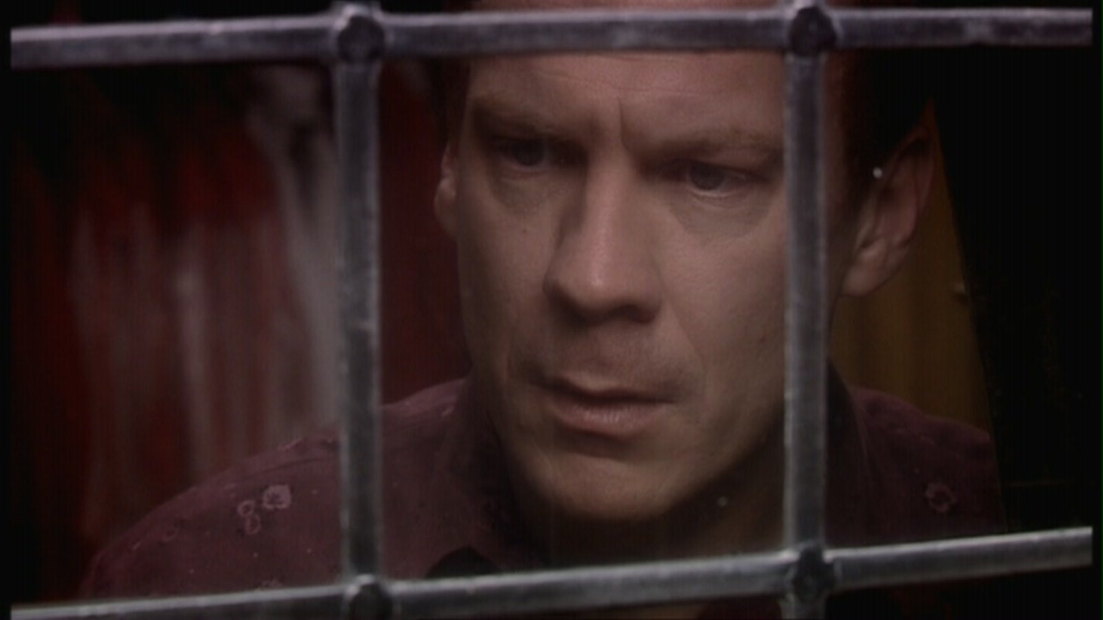 Screencap from Father's Day: the face of Pete, staring through a frosted-glass window. He looks shocked, or maybe like he's realizing something.